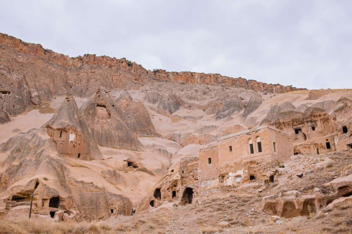 Historic cave dwellings carved into Cappadocia’s rugged cliffs, showcasing ancient rock-cut architecture in Turkey.