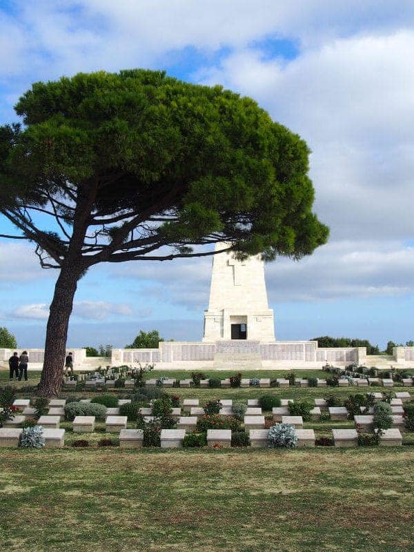 Lone Pine Cemetery and Memorial with a large pine tree and soldier graves in Gallipoli Peninsula, Çanakkale, Turkey.