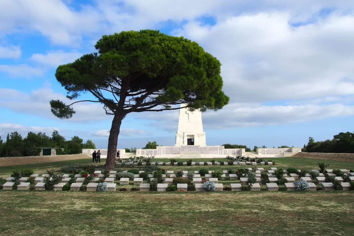 Lone Pine Cemetery and Memorial with a large pine tree and soldier graves in Gallipoli Peninsula, Çanakkale, Turkey.