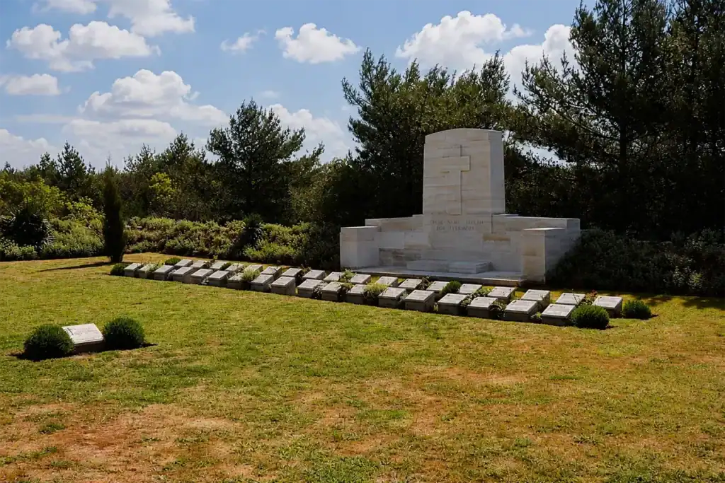 Johnston's Jolly Gallipoli memorial cemetery with white stone graves and monument surrounded by pine trees