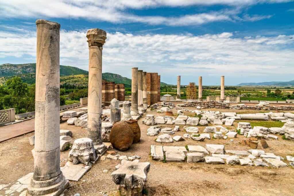 Ancient ruins of stone columns and scattered marble remains at the Basilica of St. John in Selçuk, Turkey.