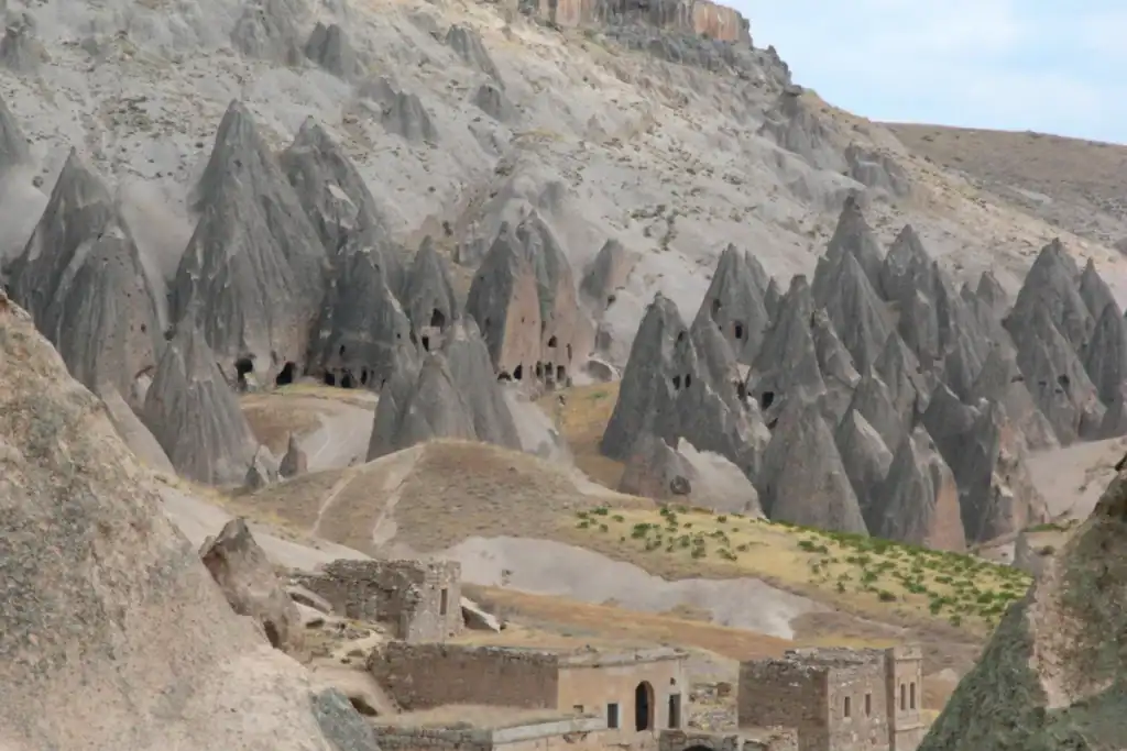 Soğanlı Valley Cappadocia cone-shaped rock formations with ancient cave dwellings carved into soft volcanic stone landscape
