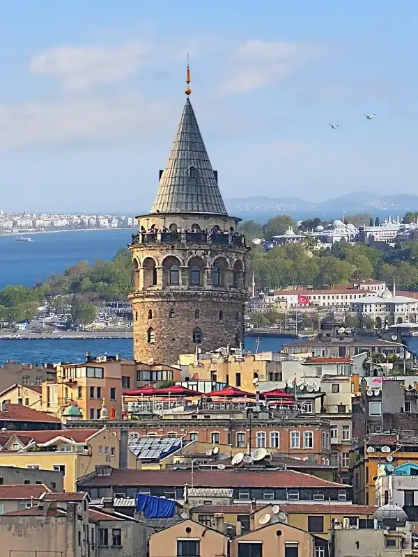 Galata Tower overlooking the Bosphorus and Istanbul skyline, historic landmark with panoramic waterfront city views.