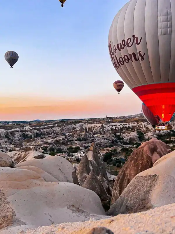 Cappadocia hot air balloons floating above fairy chimneys at sunrise, showcasing breathtaking volcanic rock landscapes.